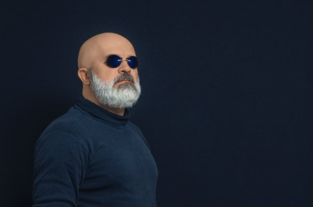 Side view of bald bearded man in dark blue glasses. Copy spaceの写真素材