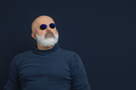 Portrait of bald bearded man in dark blue glasses. Copy spaceの写真素材