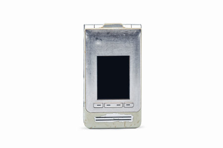 Vintage silver flip phone with worn beige body on white