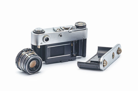 Old vintage camera disassembled on white background