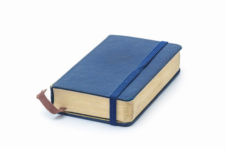 Vintage blue notebook with elastic band and bookmark on white backgroundの写真素材