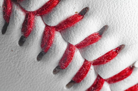 Close-up of baseball with red stitching on white leather for sports detailの写真素材