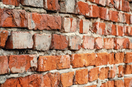 Textured Old Brick Wall with Cracks and Rough Surfaceの写真素材