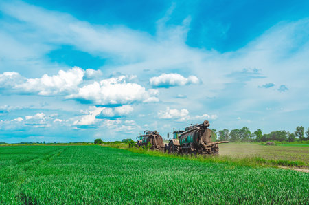 Liquid manure spreader, tractor with tank that can spray liquid manure into the soil for optimal nutrient placement. sky backgroundの写真素材