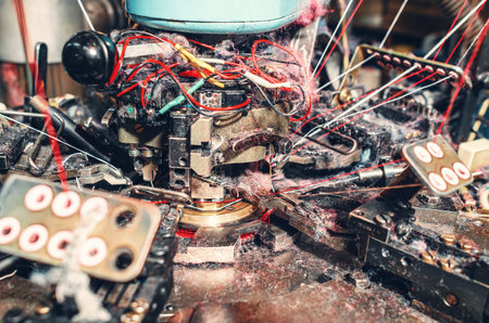 Lots of thread dust. Quality view of sock knitting machine in operation. Machinery and equipment in...