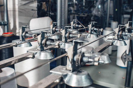 Industrial type of socks production. Sock factory, automated process of automatic socks production