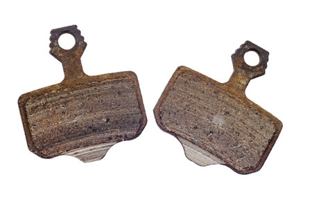 Worn bicycle brake pads placed on white background, isolated. Demonstration of their design and wear, suitability for cycling. Concept of bicycle accessories.の写真素材