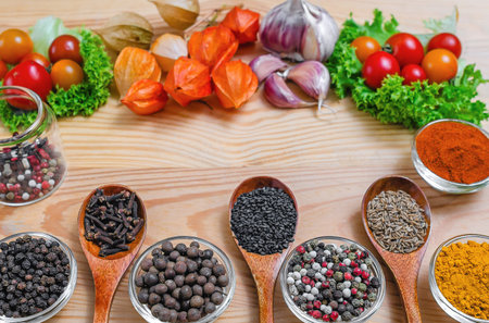 Assortment of spices and vegetables for culinary delights. Various spices and seasonings arranged on...