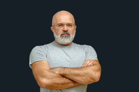 Portrait of confident man in glasses with arms crossed. Life coach or mentor, personal growth, leadership mindset and professional guidance.の写真素材