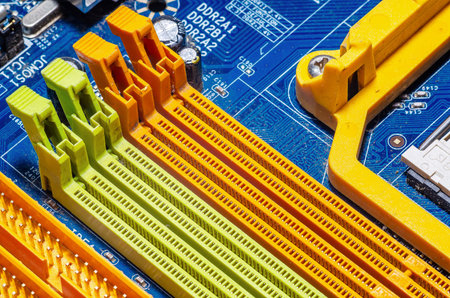 Close-up of colorful RAM memory slots on computer motherboard. Detailed macro view of electronic...