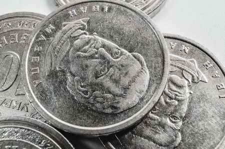 Close-up of scattered metal coins forming textured financial background. Concept of rising prices,...