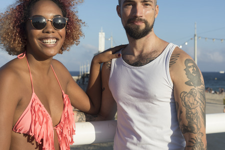 Mixed raced couple on sunny beach in summer vacationの写真素材