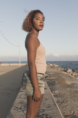 African American woman standup in shorts at Barcelona Beachの写真素材
