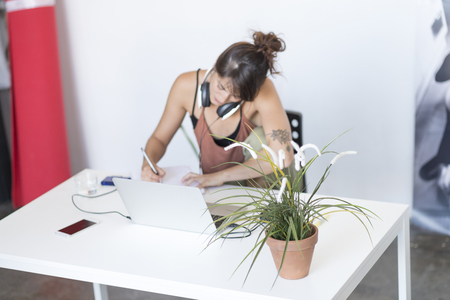 Businesswoman working on her laptop at work ( star-up concept )の写真素材