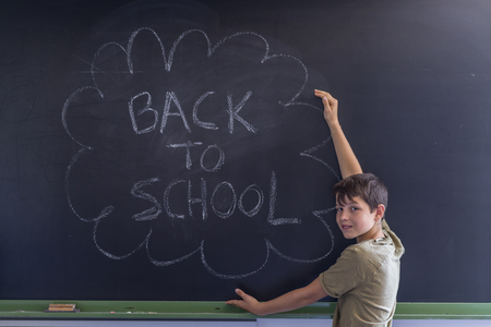 Young teen and blackboard with " back to school " written . Education conceptの写真素材