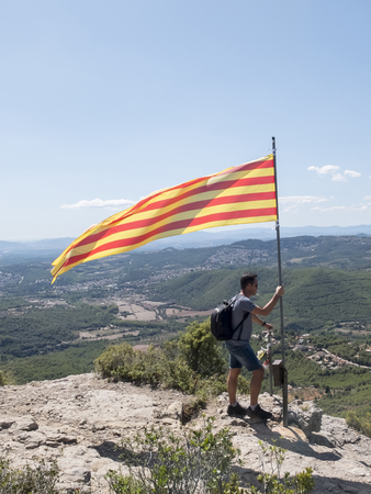 Man on top of a mountain with Catalonian flagの写真素材