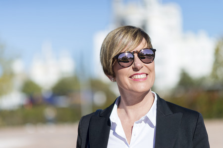 Outdoor portrait of a beautiful lady on the street wearing sunglassesの写真素材
