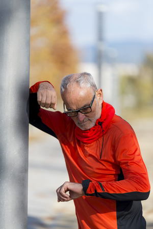 Senior man setting up the smart watchの写真素材