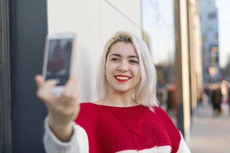 Self portrait of beautiful young blonde woman posing