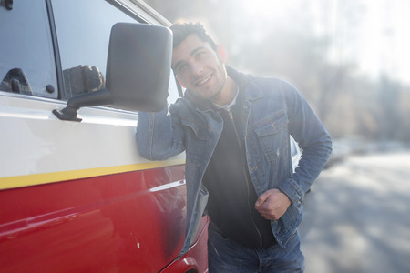 Vain man checking his looks in the mirror of his vanの写真素材