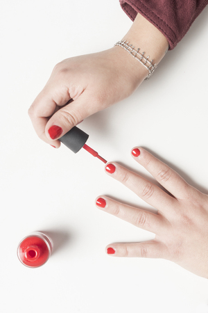 Real woman panting her nails in red colorの写真素材