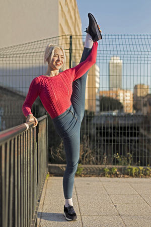 beautiful girl in a jeans in the style of ballet does the splitsの写真素材