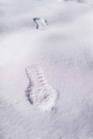 footprints on the white snow ( winter )の写真素材