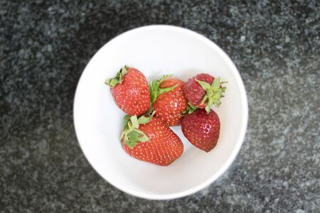 Top view of some strawberry on a white dishの写真素材