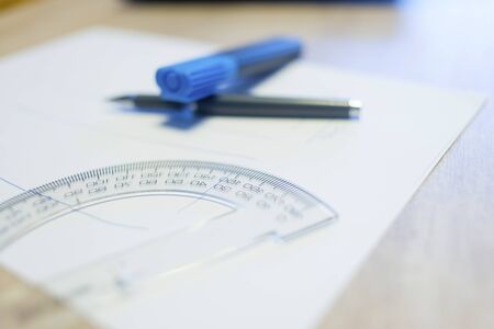 Blank white paper on wooden table with technical tools.の写真素材
