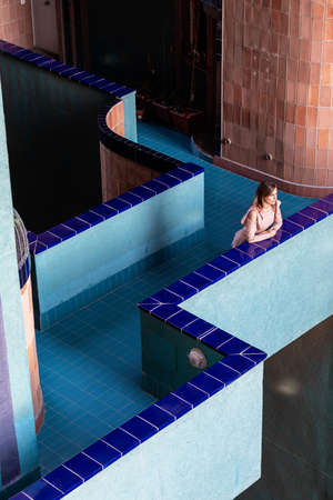 Mid adult woman leaning on balcony in a modern building