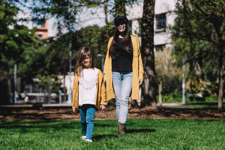 Mother with her baby. Mom and daughter in an autumn park