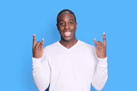 A handsome young african american man laughing gesturing