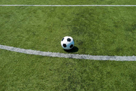 Traditional soccer ball on soccer fieldの写真素材