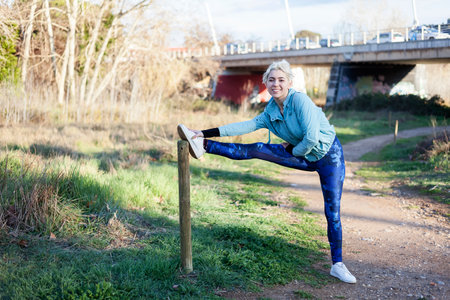 Portrait of young woman stretching and preparing for running.の写真素材