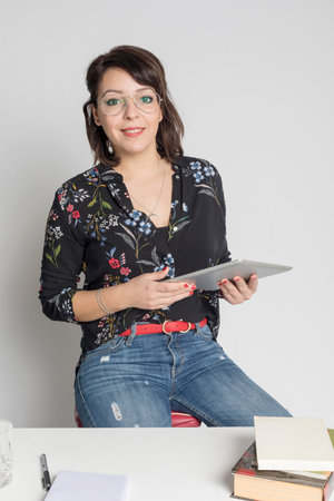 Woman using digital tablet at office, Cheerful smiling girl sitting at her workplace, Technology,...