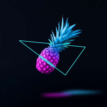 Flying retro wave pineapple in neon triangle with shadow. Minimal abstract synthwave or vaporwave. Futuristic creative idea.の写真素材