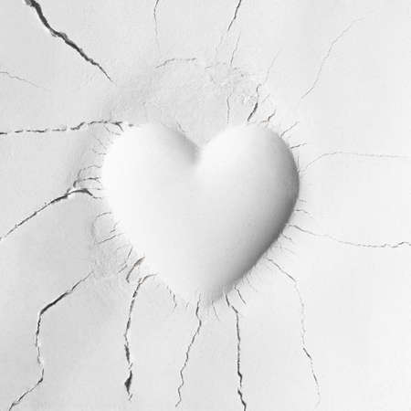 White powder texture with fossil like heart shape impression. Minimal love creative idea. Mom or Valentines day concept. Flat lay.の写真素材