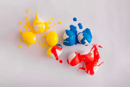 Colorful painted easter eggs on bright background. Minimal bold holiday composition. Concept of...