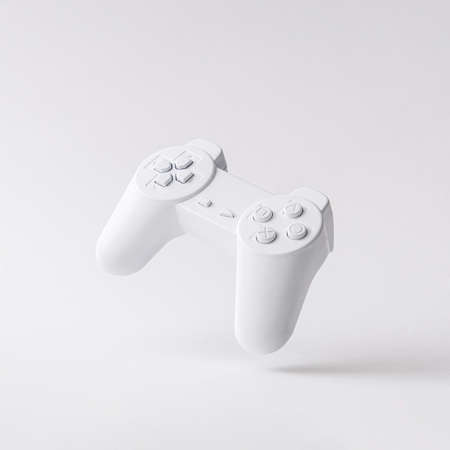 Flying or levitation gamepad or joystick on monochromatic white background. Minimal visual art idea...