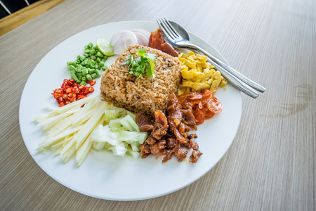 Fried rice with pork, shrimp, cucumber, onion and chow placed on the tableの写真素材