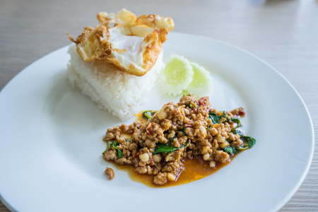 Steamed rice and pork fried with basil and fried egg. Thai food.の写真素材