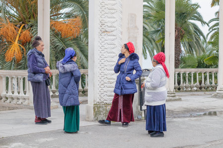 Gagra Abkhazia 27 January 2019. Conversation of four local Gypsies near the colonnade.のeditorial素材