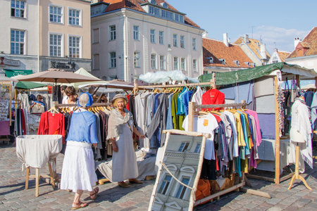 Tallinn Estonia 21 July 2018. Fair on the town hall square of Tallinn. An old woman choosing a dress.のeditorial素材