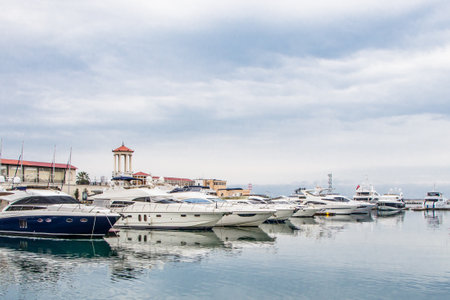 Sochi Russia February 8, 2019. Seaport in Sochi on a cloudy day. View of the yacht from the shore.のeditorial素材