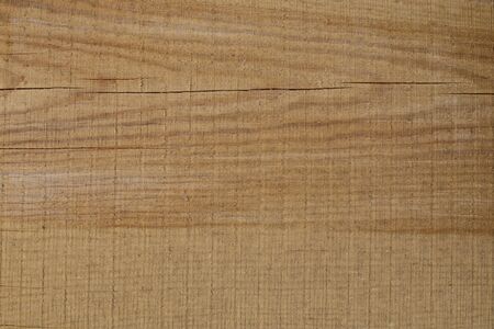Background of freshly cut brown wooden boards with cracks. Horizontal stripes.の写真素材