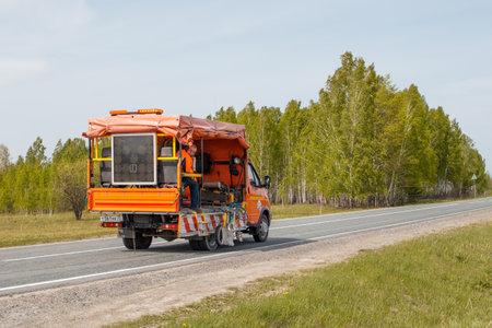 Aromashevo, Russia, May 27,2019. A marking machine applies horizontal markings on a road with paint. Siberiaのeditorial素材
