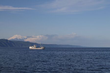 View of lake Baikal near the city of Slyudyanka, Irkutsk region, Russia. Landscape with a fishing boat.の写真素材