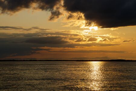 Sunset with black clouds on the Amur River, Khabarovsk Territory, Russiaの写真素材