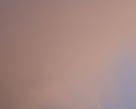 A coral hue cloud background with a small part of the blue sky in the corner.の写真素材