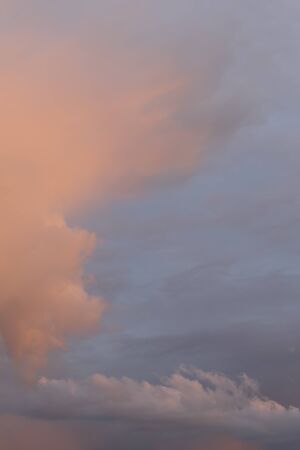 Sky after rain with cirrus clouds of coral and blue. Vertical.の写真素材